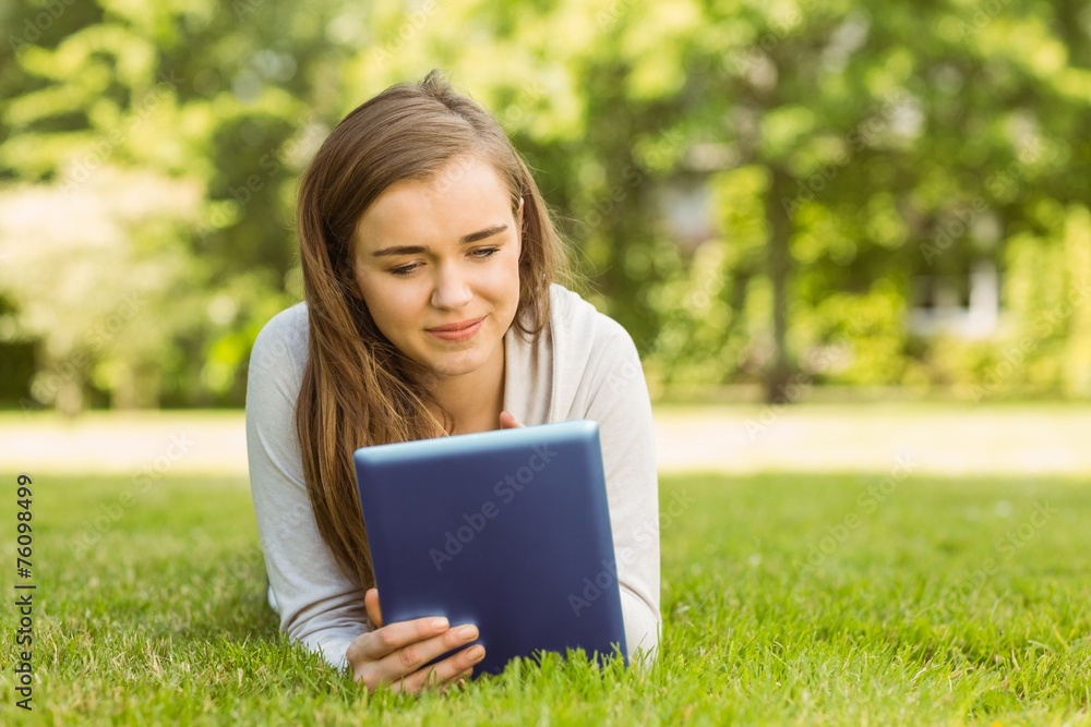 University student lying and using tablet pc University student lying and using tablet pc