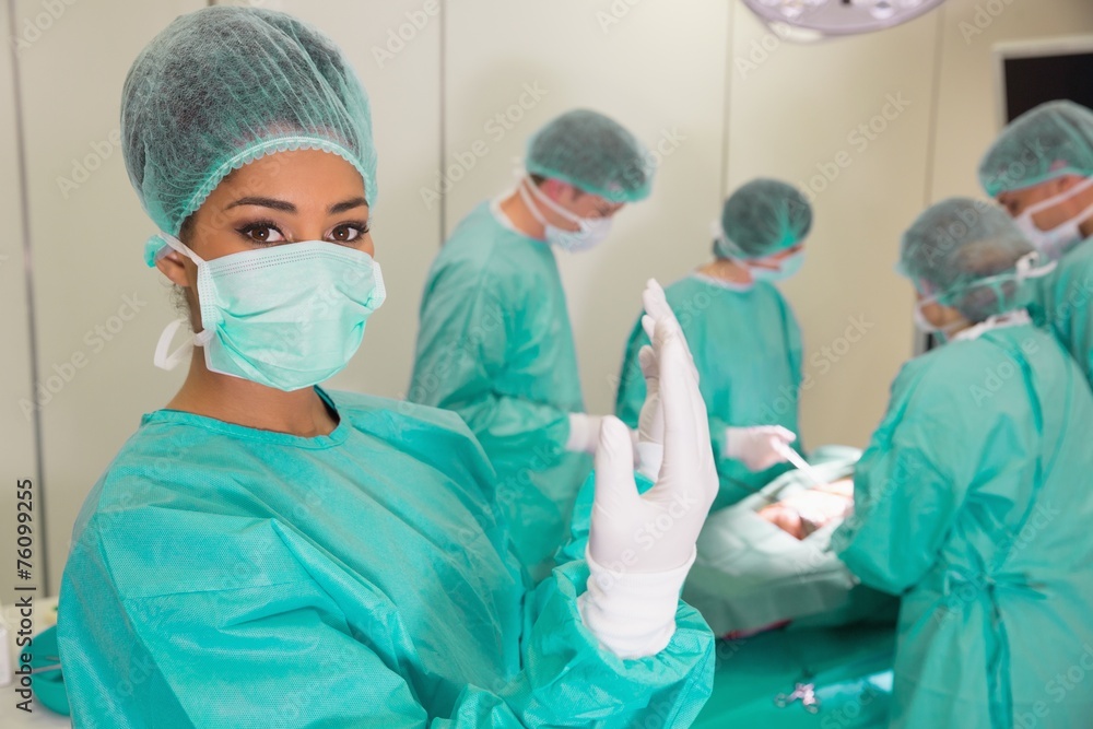 Medical students practicing surgery on model Medical students practicing surgery on model