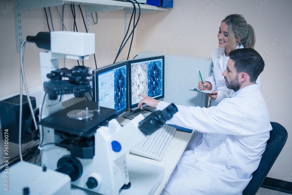 Science students looking at microscopic images Science students looking at microscopic images