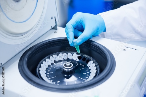 Close up of a chemist using a centrifuge photo