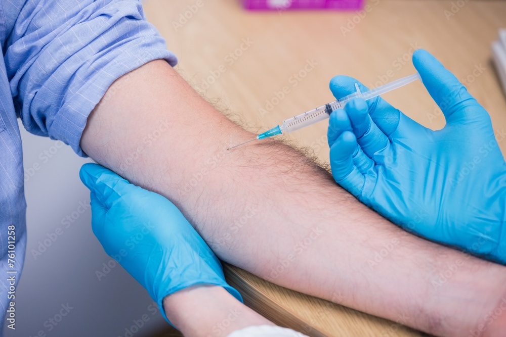 Close up of a patient receiving injection Close up of a patient receiving injection