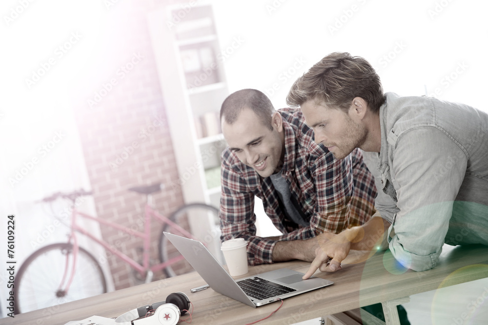 Young men studying in front of laptop Young men studying in front of laptop