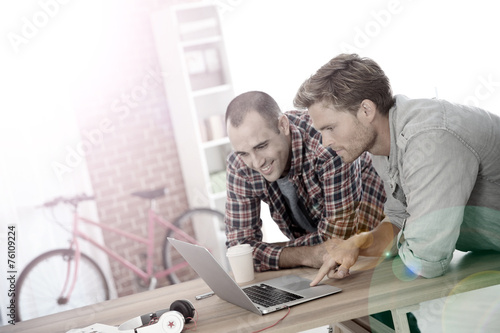 Young men studying in front of laptop