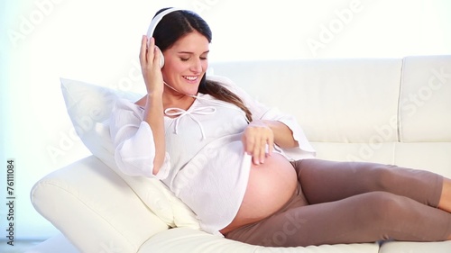 pregnant woman sharing her favorite song with her future baby