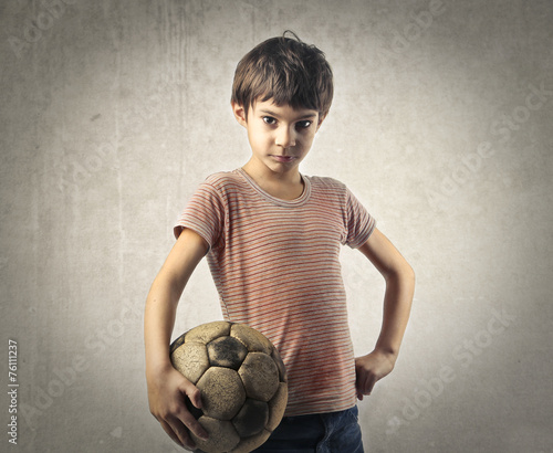 Young child playing football