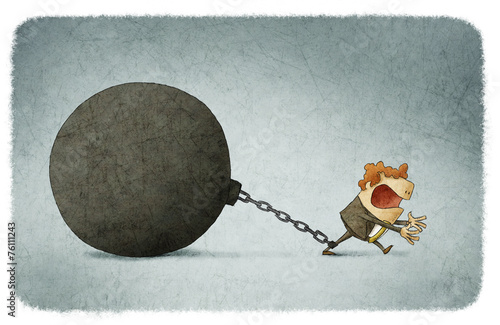 Businessman chained to a large ball
