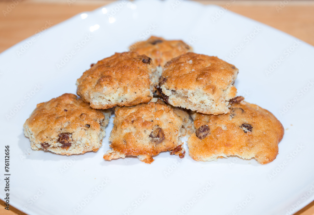Handmade crisp biscuits with raisin on white plate Handmade crisp biscuits with raisin on white plate