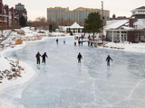 People skate at early evening on a frozen lake