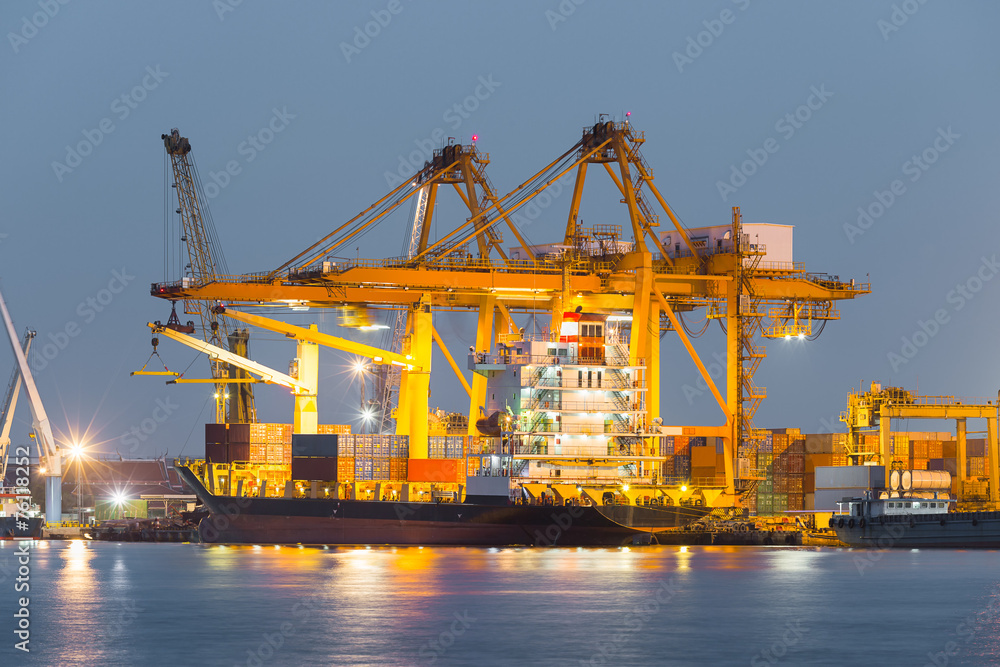 Gantry crane loading and unloading cargo container from cargo ship at port to show global international logistics and transportation by cargo ship and cargo container, Logistic import export concept. Gantry crane loading and unloading cargo container from cargo ship at port to show global international logistics and transportation by cargo ship and cargo container, Logistic import export concept.