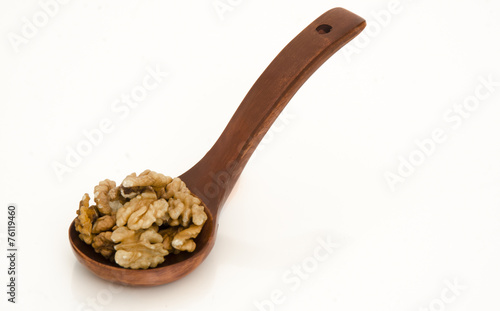 Walnuts in a wood spoon