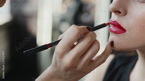 Lipstick on red lips of fashion model