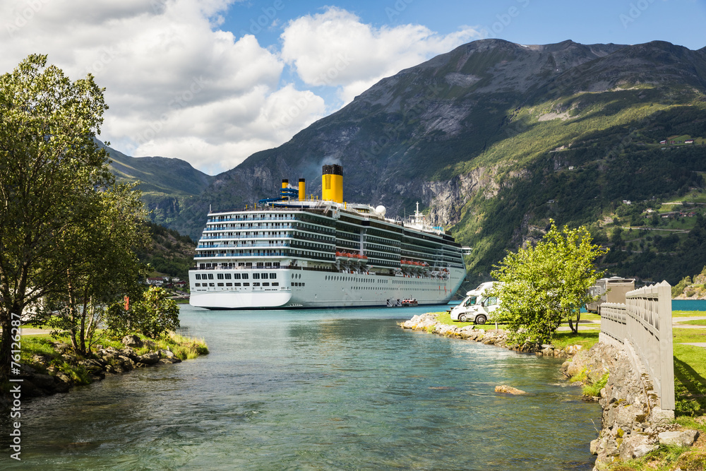 Large luxury cruise ship anchored in fjord and camping cars