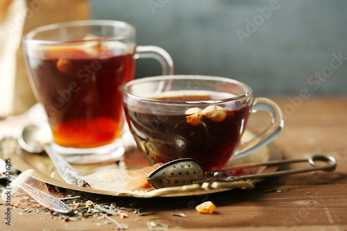 Beautiful vintage composition with herbal tea, on wooden table