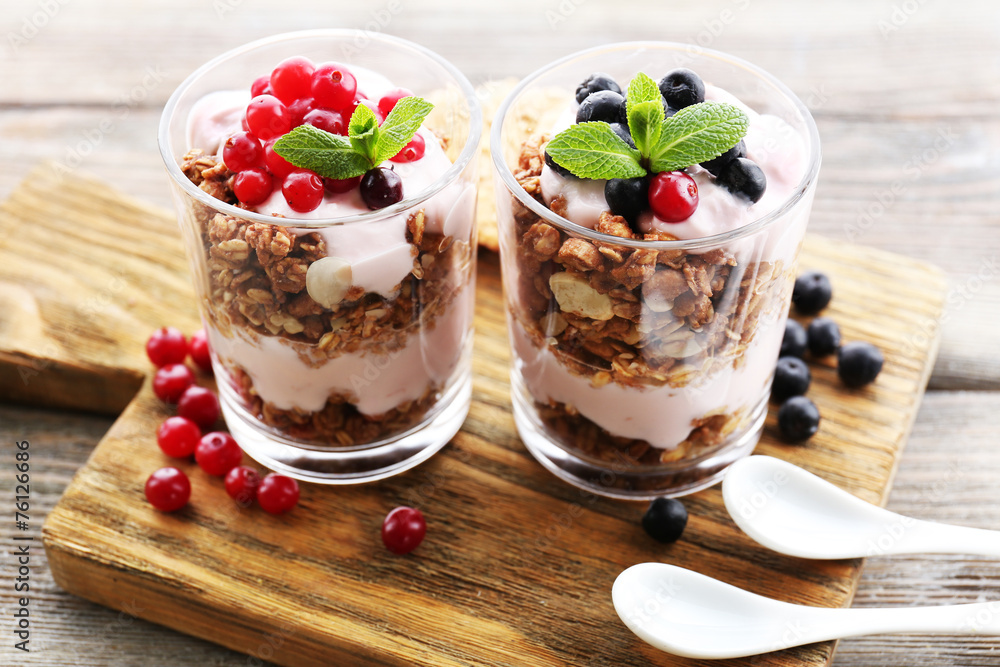 Healthy layered dessert with muesli and berries on table Healthy layered dessert with muesli and berries on table