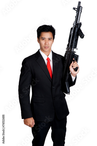 business man holding machine gun