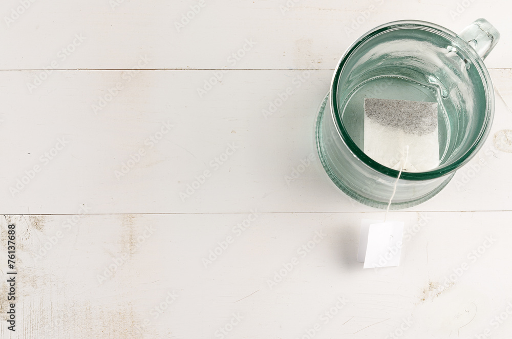 Empty tea glass with tea bag top right corner Empty tea glass with tea bag top right corner
