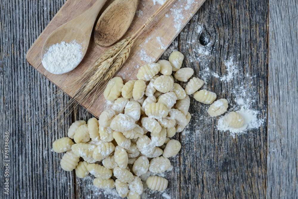 Gnocchi on Cutting Board and Rustic Wood Background Gnocchi on Cutting Board and Rustic Wood Background