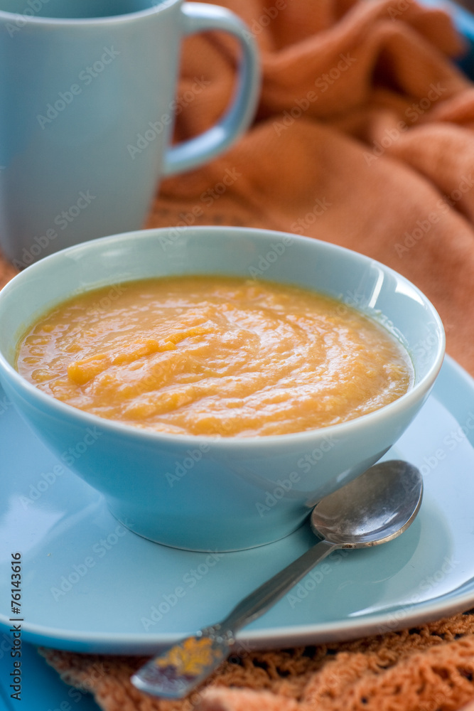Dietary pumpkin porridge in the blue plate Dietary pumpkin porridge in the blue plate