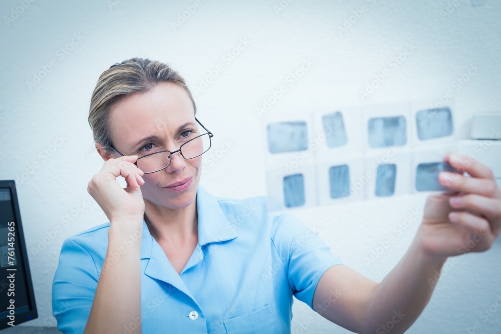 Female dentist looking at x-ray Female dentist looking at x-ray