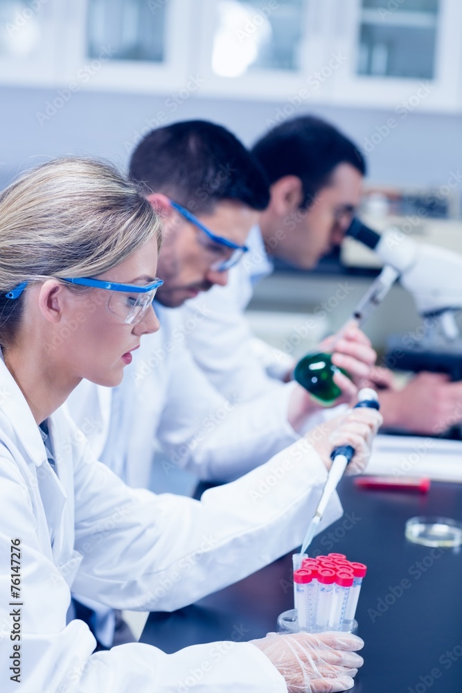 Science students working with chemicals in lab Science students working with chemicals in lab