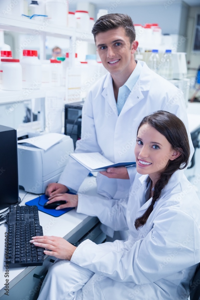 Chemist team working together at desk using computer Chemist team working together at desk using computer