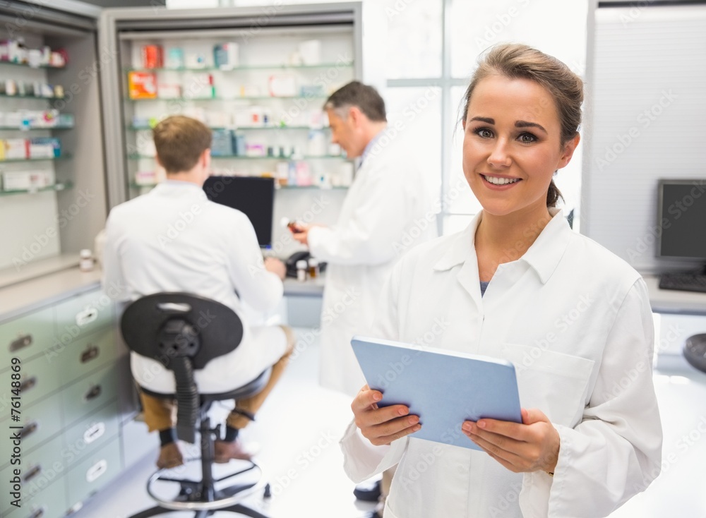 Junior pharmacist using tablet pc Junior pharmacist using tablet pc