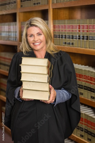 Lawyer holding books in the law library