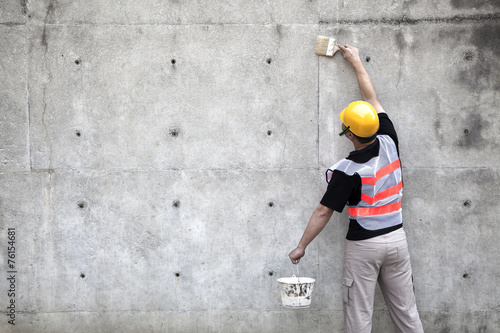 painter working on the old concrete wall