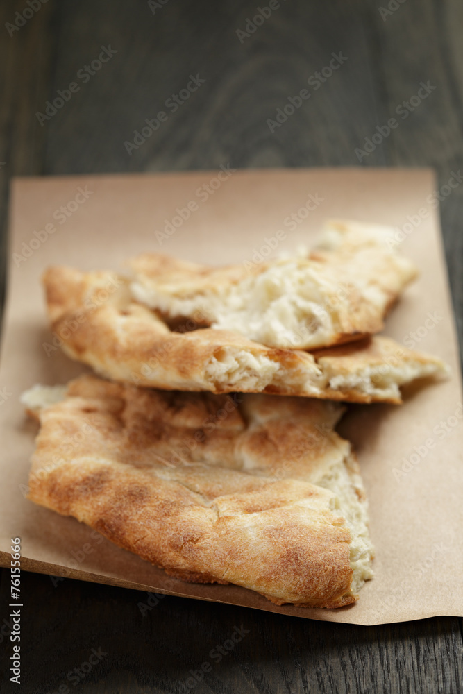 freshly baked georgian pita bread on paper