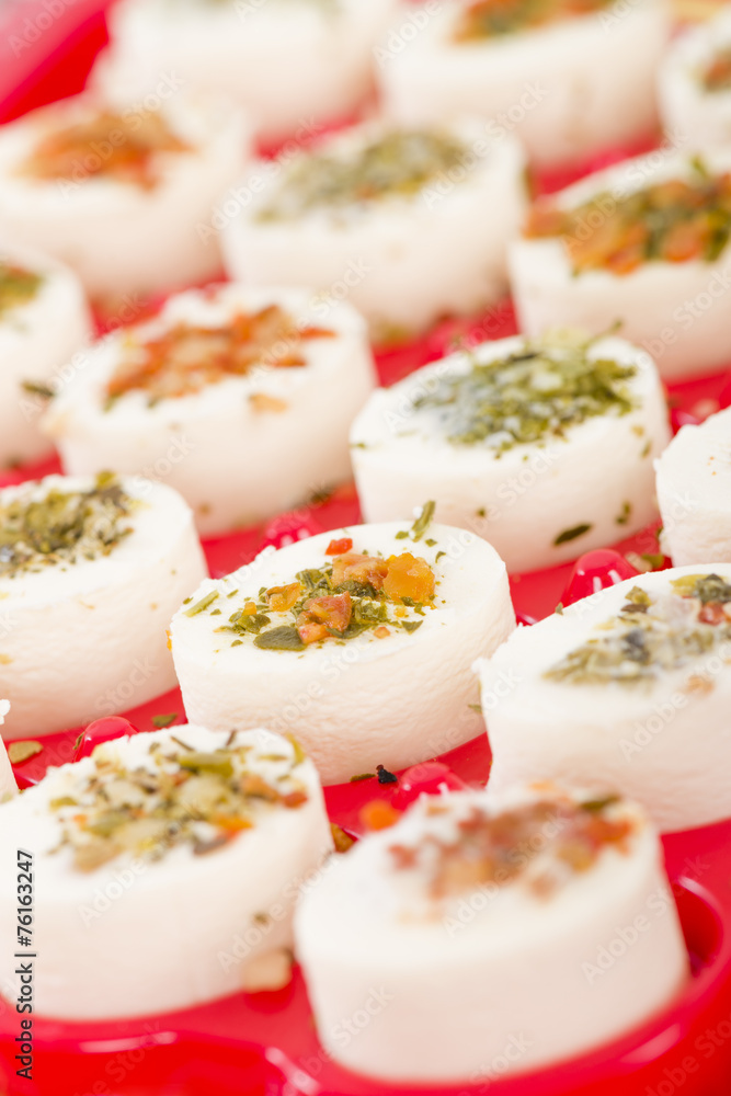 Cheese Appetisers - Soft cheese topped with herbs and spices.