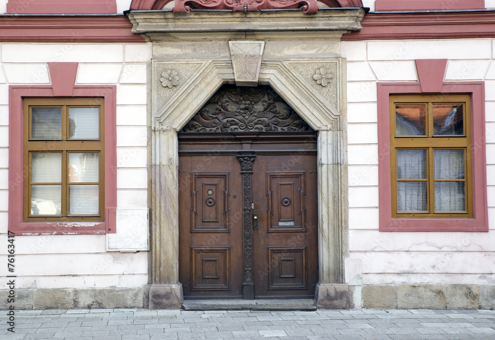 Detail of vintage townhouse in Czech with old door and windows