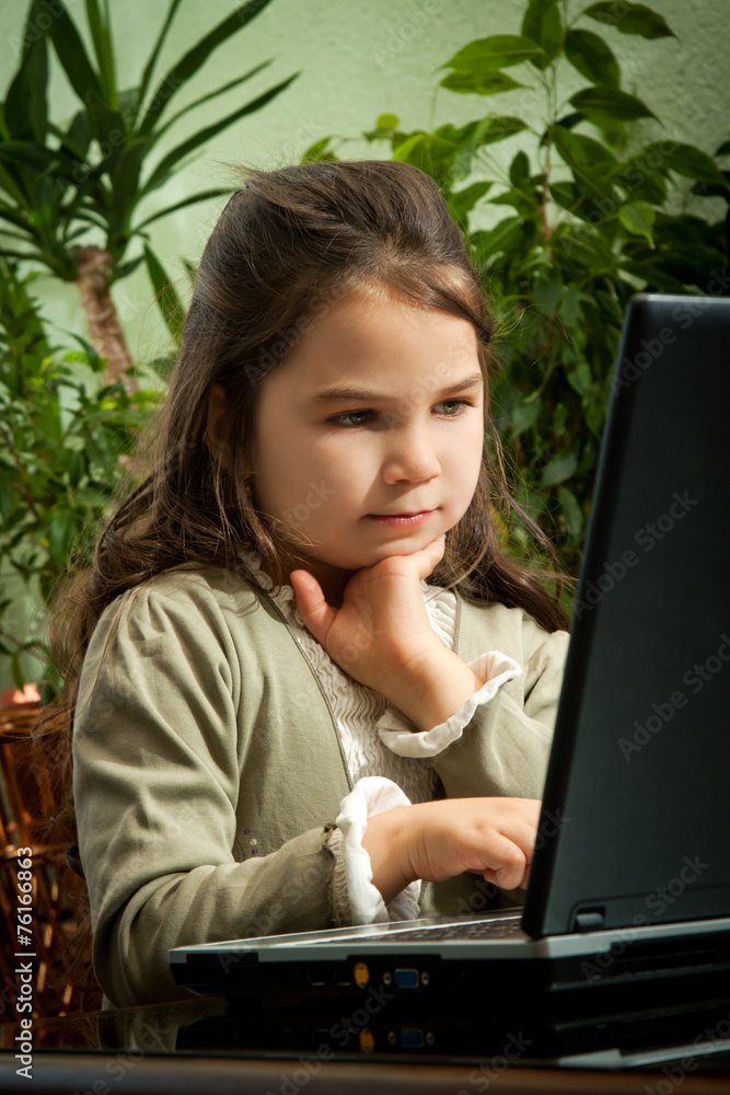 Cute little girl learning on her laptop Cute little girl learning on her laptop