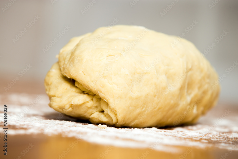 Piece of kneaded dough on the table Piece of kneaded dough on the table