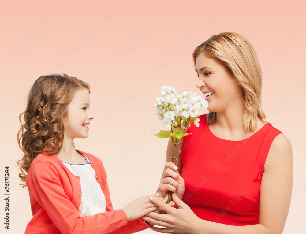 happy little daughter giving flowers to her mother happy little daughter giving flowers to her mother