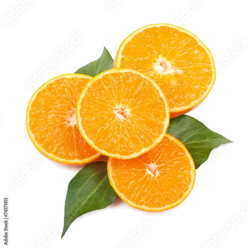 Mandarin orange slices with leaves on a white background