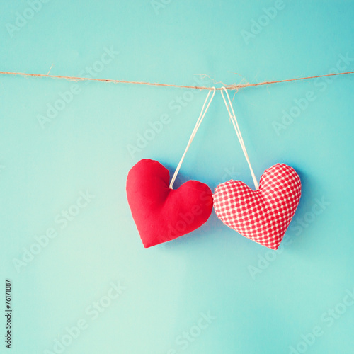 Vintage stuffed cotton hearts hanging on a line