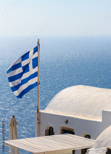 Greek flag on roof of Santorini house