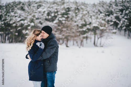 Young couple walking in a winter countryside