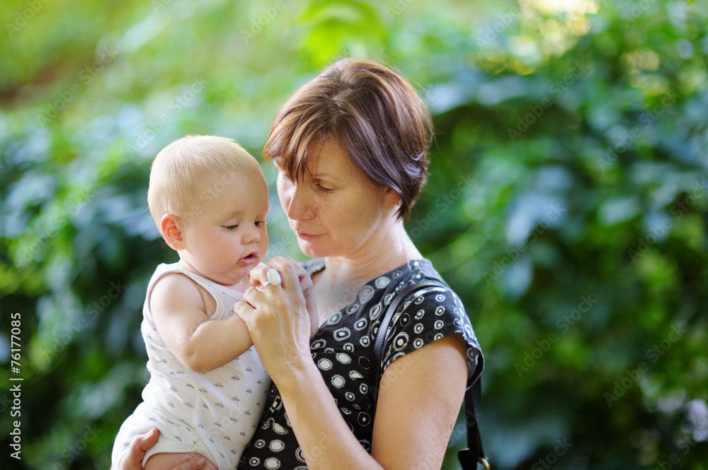 Beautiful middle aged woman and her adorable little grandson Beautiful middle aged woman and her adorable little grandson