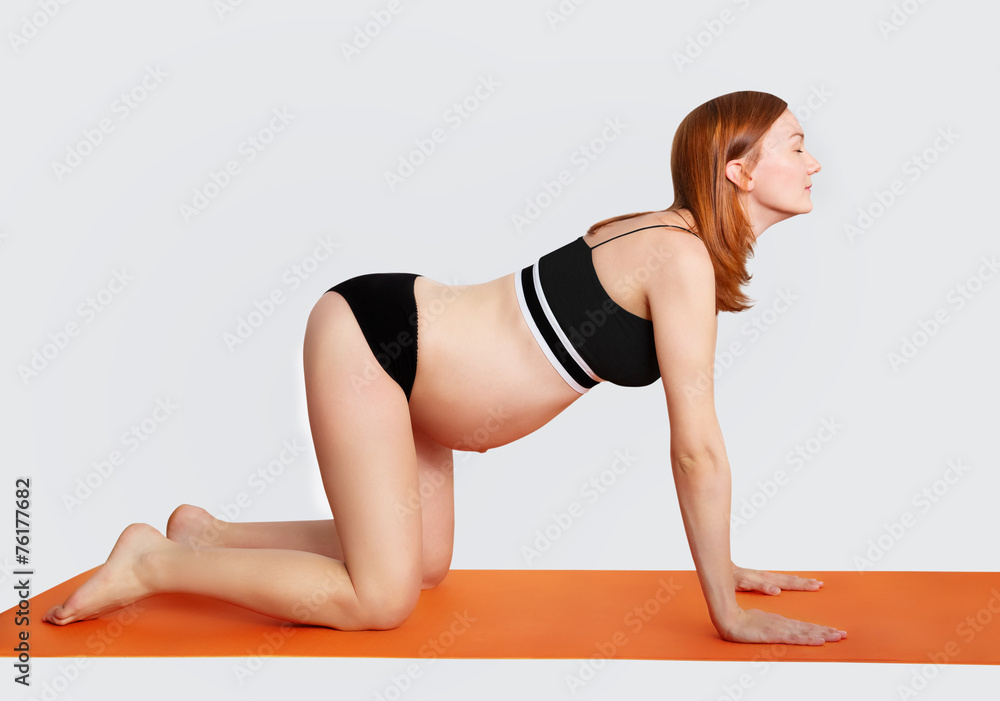 Fototapeta premium Pregnant woman doing yoga and relaxing