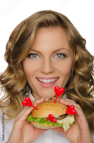 Beautiful young woman with hamburger from hearts