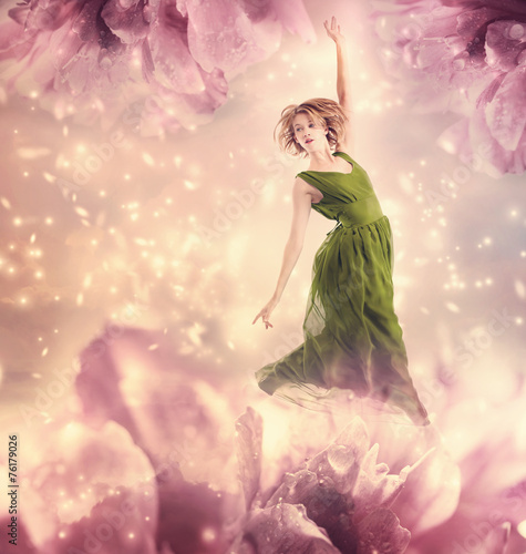 Beautiful woman jumping in a pink peony flower fantasy