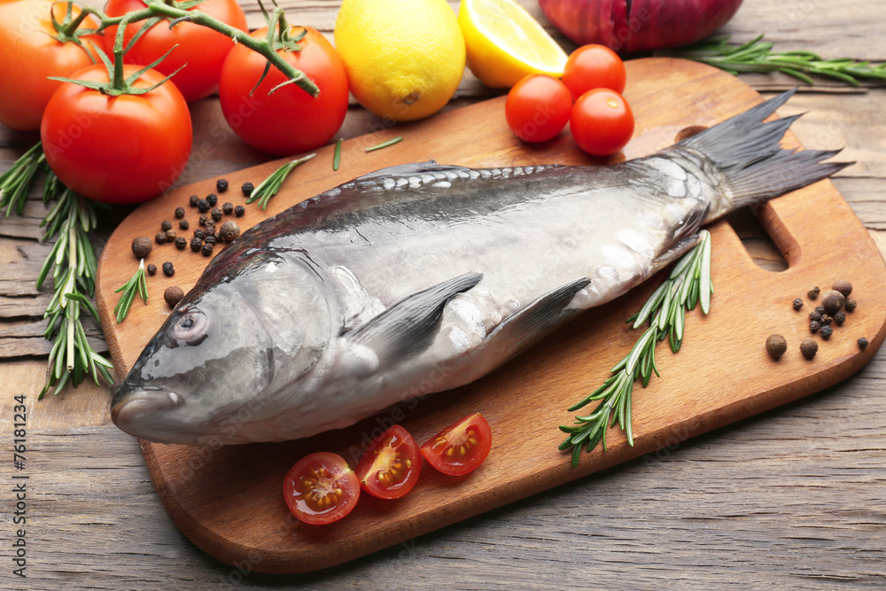 Fresh raw fish and food ingredients on table Fresh raw fish and food ingredients on table