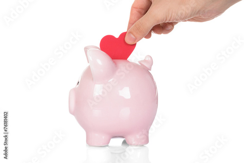 Hand Deposit Red Heart In Piggy Bank