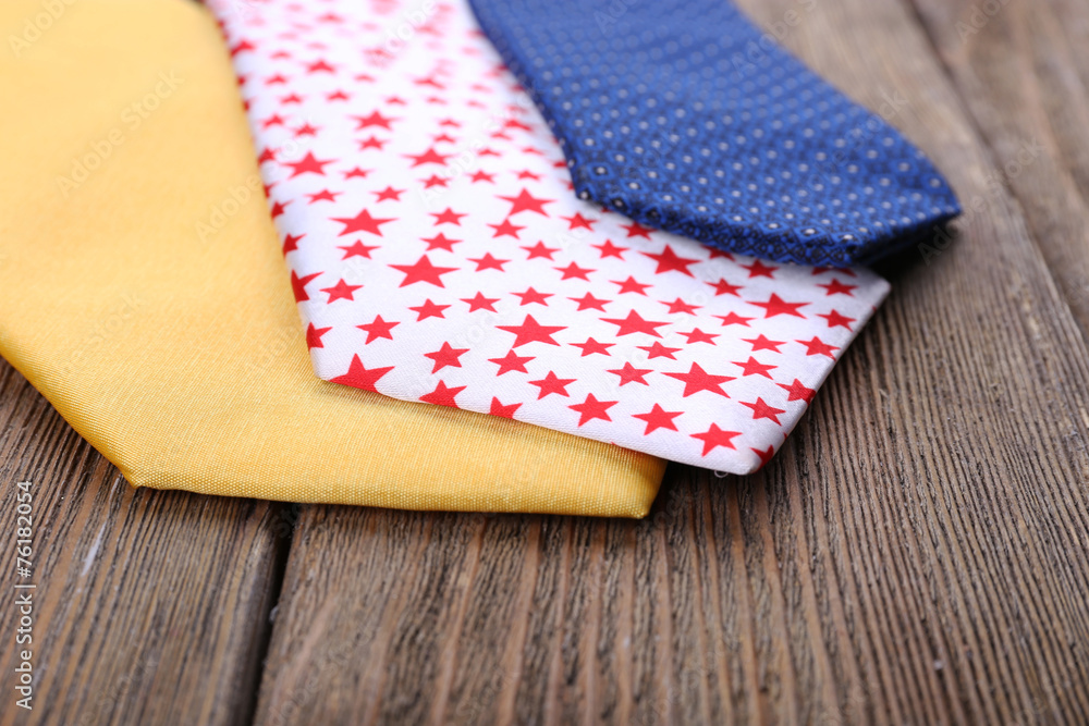 Different Ties on wooden planks background Different Ties on wooden planks background