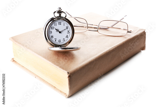 Silver pocket clock and book isolated on white