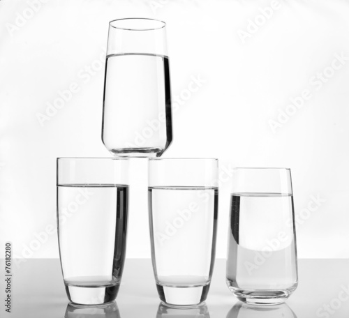 Glasses of water on light background