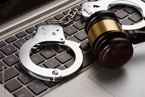 Gavel And Handcuffs On Laptop