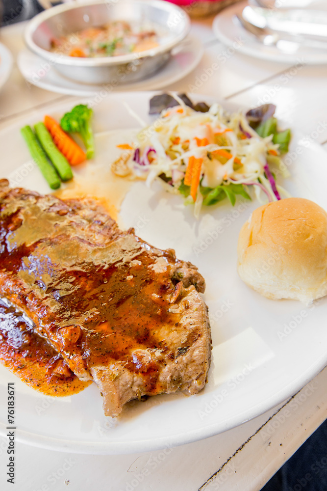 Grilled steaks,bread and vegetable salad Grilled steaks,bread and vegetable salad