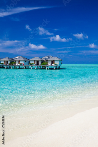 Water villas in the ocean and white sandy beach
